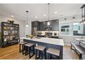 Modern kitchen with stainless steel appliances, a large island, and stylish pendant lighting at 3814 Zenobia St, Denver, CO 80212