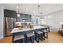 Bright kitchen featuring modern cabinets, stainless steel appliances, and a spacious island with seating at 3814 Zenobia St, Denver, CO 80212