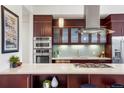 Modern kitchen featuring stainless steel appliances, sleek countertops, and rich wood cabinetry at 2518 N Washington St, Denver, CO 80205