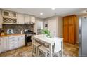 Charming kitchen boasts stainless steel appliances, butcher block countertops, and a center island with seating at 2080 Fulton St, Aurora, CO 80010