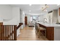 Spacious entryway with kitchen island and staircase leading to the home's upper level at 690 S Newark Ct, Aurora, CO 80012