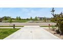 View of a neighborhood park featuring a playground, grassy area, and walking paths at 6404 Dry Fork Dr, Frederick, CO 80516