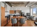 Modern kitchen with stainless steel appliances, wood cabinets and eat-in island at 1401 Wewatta St # 911, Denver, CO 80202