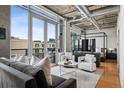 Contemporary living area featuring a balcony, modern seating, and a view at 1401 Wewatta St # 911, Denver, CO 80202