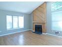 Bright living room features a fireplace with wood paneling and large windows for natural light at 9669 W Chatfield Ave # A, Littleton, CO 80128