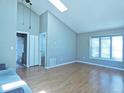 Open floorplan living room with vaulted ceilings and a skylight for ample natural light at 9669 W Chatfield Ave # A, Littleton, CO 80128
