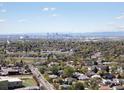 Expansive aerial view showcasing the city skyline, lush greenery, and surrounding neighborhoods at 2433 E 90Th Ave, Thornton, CO 80229