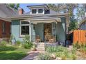 Charming home with a manicured front yard, quaint porch, and beautiful landscaping at 2445 N Franklin St, Denver, CO 80205