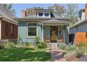 Classic home featuring a well-maintained lawn, cozy porch, and welcoming facade at 2445 N Franklin St, Denver, CO 80205