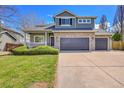 Charming two-story home with a stone facade and a well-manicured lawn at 17280 W 70Th Ave, Arvada, CO 80007