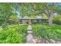 Beautiful single-story home with lush greenery and a well-maintained lawn at 8600 W 2Nd Ave, Lakewood, CO 80226
