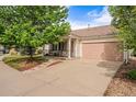 Well-maintained single-Gathering home featuring a cozy front porch, two-car garage, and inviting landscaping at 19481 E 50Th Pl, Denver, CO 80249