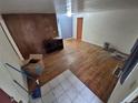 Empty living room showcasing hardwood floors, wood paneling, and tile entry, awaiting personalization at 1078 Elmira St, Aurora, CO 80010
