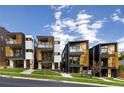 Modern townhomes showcase sleek architectural designs with balconies, wood accents, and well-manicured lawns at 1262 N Stuart St # 2, Denver, CO 80204