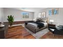 Bright main bedroom with hardwood floors, neutral walls, and stylish modern furniture at 2675 Quitman St, Denver, CO 80212