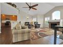 Open-concept living room with hardwood floors, a ceiling fan, and a fireplace at 3325 W 111Th Loop # C, Westminster, CO 80031