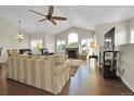 Bright living room with vaulted ceilings, a fireplace, and hardwood floors at 3325 W 111Th Loop # C, Westminster, CO 80031