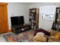 Inviting living room with television, book shelves and area rug at 933 Skeel St, Brighton, CO 80601