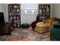 Inviting living room with a comfortable seating area and stylish bookshelves at 933 Skeel St, Brighton, CO 80601