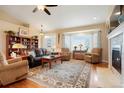 Comfortable living room with hardwood floors, a fireplace, a large bay window and plush seating at 34682 Stampede Cir, Elizabeth, CO 80107