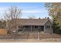 Charming home exterior with beautiful landscaping, featuring a brick facade and well-maintained yard at 3327 Irving St, Denver, CO 80211