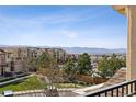Scenic view from the home overlooking lush greenery, buildings, and distant mountains under a bright sky at 9456 Rockhurst St # F, Highlands Ranch, CO 80129
