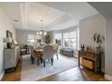 Elegant dining room featuring tray ceilings, large windows, and a modern chandelier for sophisticated meals at 6155 Puma Pt, Lone Tree, CO 80124