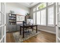 Well-lit office with a large window, built-in bookshelves, and a spacious desk perfect for productivity at 6155 Puma Pt, Lone Tree, CO 80124