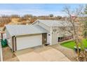 Charming home with a two-car garage, brick accents, green grass, and well-kept landscape at 228 Birch Ave, Castle Rock, CO 80104