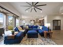 Open-concept living room with plush blue sectional sofa and view into kitchen at 23030 E Del Norte Cir, Aurora, CO 80016