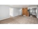 Spacious living area with new carpet, neutral paint, and easy access to kitchen and bedrooms at 444 S Jersey St, Denver, CO 80224