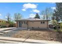 Charming brick home with a well-manicured front yard and inviting blue front door at 7496 Clay St, Westminster, CO 80030