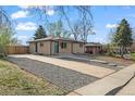 Charming brick home with a well-manicured front yard and inviting blue front door at 7496 Clay St, Westminster, CO 80030