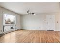 Spacious living room with hardwood floors and a large window for natural light at 7412 W 76Th Ave, Arvada, CO 80003