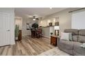 Open-concept living and dining area with modern decor and hardwood flooring at 9172 W 88Th Cir, Westminster, CO 80021