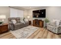 Comfortable living room with plush seating, a large TV, and stylish decor at 9172 W 88Th Cir, Westminster, CO 80021