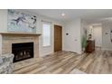Inviting living room featuring a fireplace, hardwood floors, and fresh neutral paint at 9172 W 88Th Cir, Westminster, CO 80021