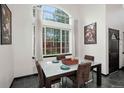 Bright dining room with a large window, a modern table, and stylish decor at 1415 S Chambers #106 Rd, Aurora, CO 80017