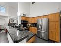 Spacious kitchen with granite countertops, stainless steel appliances, and wood cabinets at 1415 S Chambers #106 Rd, Aurora, CO 80017