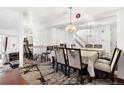 Elegant dining room with large mirror, ornate chandelier, and seating for eight is perfect for entertaining at 1885 S Quebec Way # G104, Denver, CO 80231