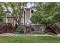 Charming multi-level home with brick accents, lush green lawn and mature shade trees enhance curb appeal at 1885 S Quebec Way # G104, Denver, CO 80231