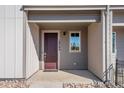 Inviting front porch with stylish front door, house numbers and window at 16794 W 94Th Way, Arvada, CO 80007