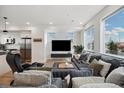 Bright living room featuring an oversized gray couch, modern entertainment center, and large windows for natural light at 3101 W 47Th Ave # 14, Denver, CO 80211