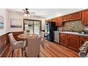 Cozy kitchen and dining area featuring wood floors and a sliding glass door to outdoor living space at 9125 Lowell Ct, Westminster, CO 80031