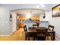 Kitchen open to dining area features stainless appliances, granite countertops, and ample cabinet space at 4222 S Blackhawk Cir # 6C, Aurora, CO 80014