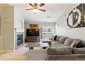 Comfortable living room with fireplace, ceiling fan, and ample seating at 4222 S Blackhawk Cir # 6C, Aurora, CO 80014