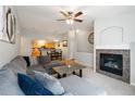 Open living area with fireplace, connecting to the kitchen and dining areas at 4222 S Blackhawk Cir # 6C, Aurora, CO 80014