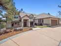 Lovely home with tile roof, neutral stucco and concrete driveway at 902 Anaconda Ct, Castle Rock, CO 80108