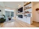 Bright living room boasts hardwood floors, a modern fireplace, and a sliding door to an outdoor patio at 1998 Foxtail Ln # B, Lafayette, CO 80026