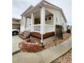 Well-kept two-story home featuring a covered front porch, complemented by a landscaped front yard at 20308 E 48Th Dr, Denver, CO 80249